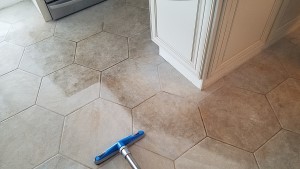 technician steam cleaning kitchen grout in Howell NJ
